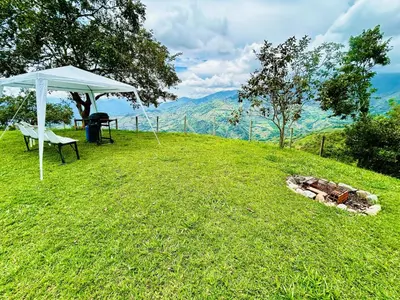 a tent and a table and a chair on a hill at Almalu Finca in Filadelfia