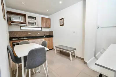 a kitchen with a table and chairs in a room at El Poblado 4 Bedrooms 2 Baths Private Terrace in Medellín