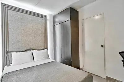 a bedroom with a large bed and a closet at El Poblado 4 Bedrooms 2 Baths Private Terrace in Medellín