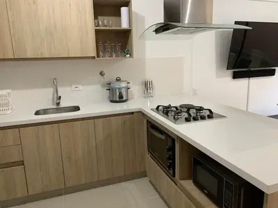 a kitchen with a stove and a sink at Casa en San Antonio de Pereira in Rionegro