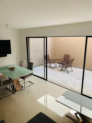 a living room with a glass table and chairs at Casa en San Antonio de Pereira in Rionegro