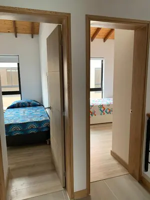 a room with a door open to a bedroom with a bed at Casa en San Antonio de Pereira in Rionegro