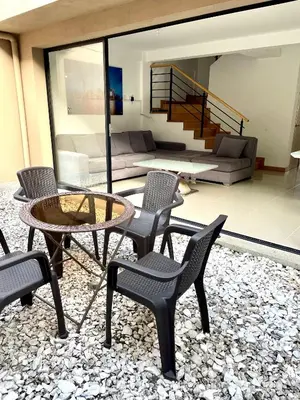 a living room with chairs and a table and a couch at Casa en San Antonio de Pereira in Rionegro