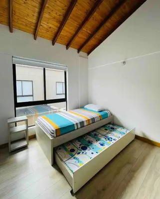 a bedroom with two bunk beds and a window at Casa en San Antonio de Pereira in Rionegro