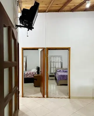 a room with two mirrors and a room with two beds at Los micos in San Rafael