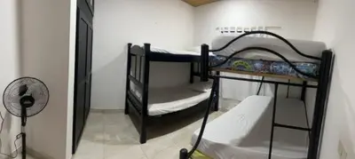 two bunk beds in a room with a fan at Los micos in San Rafael