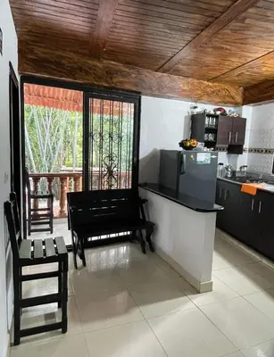 a kitchen with a table and a stove and a counter at Los micos in San Rafael