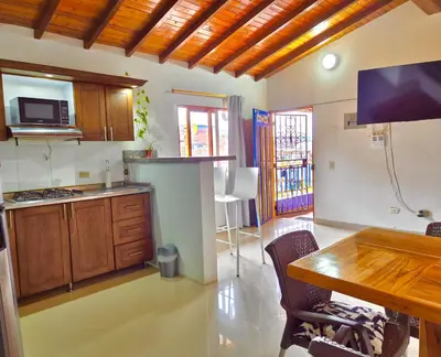 a kitchen with a table and a dining room at Apartamento central en Guatape - 2 habitaciones - 2 baños - Ideal familias in Guatapé