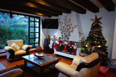 a living room with a christmas tree and a fireplace at VILLA DOLLS PRIVADA CON SAUNA, PISCINA Y MAs in Rionegro