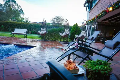a patio with chairs and a swimming pool at VILLA DOLLS PRIVADA CON SAUNA, PISCINA Y MAs in Rionegro