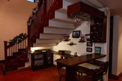 a dining room with a table and a staircase at VILLA DOLLS PRIVADA CON SAUNA, PISCINA Y MAs in Rionegro