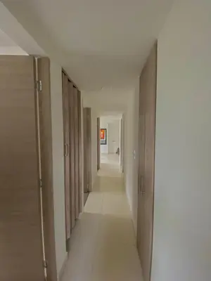 a hallway with wooden doors and a long corridor at Apartamento en Manizales in Manizales