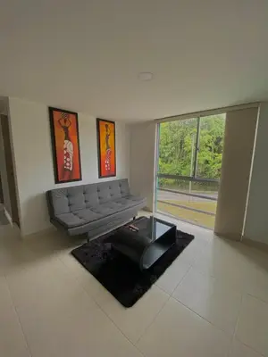 a living room with a couch and a large window at Apartamento en Manizales in Manizales