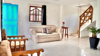 a living room with a couch and a staircase at Casa Guatapé in Guatapé