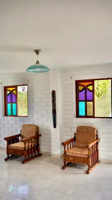 two chairs in a room with stained glass windows at Casa Guatapé in Guatapé