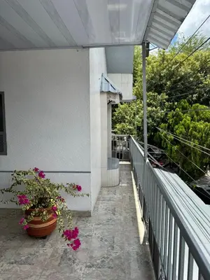 a balcony of a house with flowers on it at Hotel Regional in La Dorada
