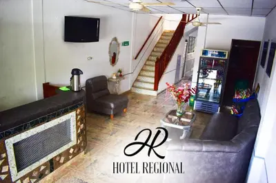 a living room with a couch and a television at Hotel Regional in La Dorada