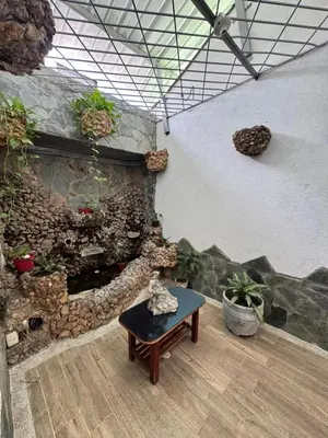 a room with a stone wall and a table with plants at Hotel Regional in La Dorada