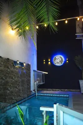 a swimming pool with a sign that reads at Hotel Regional in La Dorada