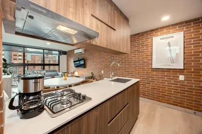 a kitchen with a stove and a counter top at Kyux Studios by MOME in Medellín