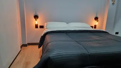 a bedroom with a large bed with two pillows at Casa 1982 in Manizales