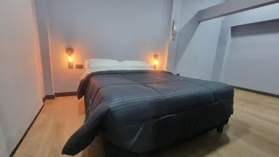 a bed in a room with two white pillows at Casa 1982 in Manizales