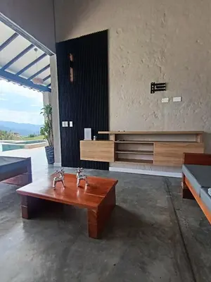 a living room with a bench and a wooden table at Casa Elixir Sopetrán in Sopetran