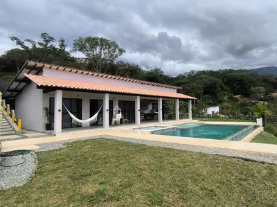 a house with a swimming pool in front of it at Casa Elixir Sopetrán in Sopetran