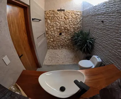 a bathroom with a sink and a stone shower at Casa Elixir Sopetrán in Sopetran