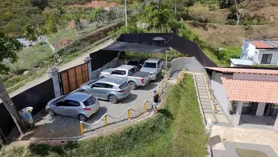 a group of cars parked in a parking lot at Casa Elixir Sopetrán in Sopetran