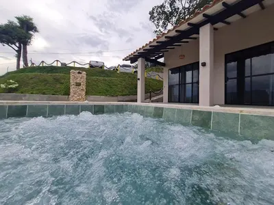 a pool of water in front of a house at Casa Elixir Sopetrán in Sopetran