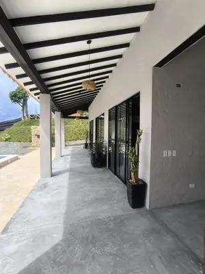 a porch of a house with a ceiling at Casa Elixir Sopetrán in Sopetran
