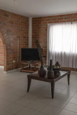 a living room with a table with vases on it at Finca campestre de 2 pisos en Guarne in Guarne