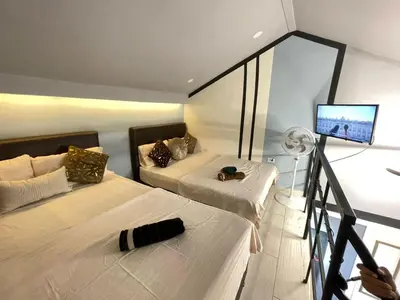 a room with two beds and a flat screen tv at apartamento duplex la 70 estadio laurles in Medellín