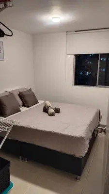 a bed with a stuffed animal laying on it in a room at Apartment in Envigado with a pool in Envigado