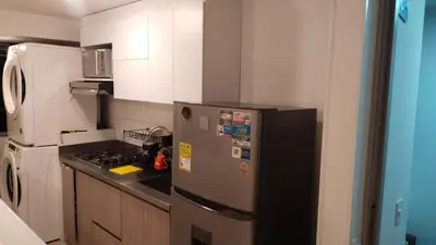 a kitchen with a refrigerator and a stove at Apartment in Envigado with a pool in Envigado