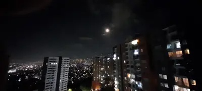 a view of a city at night with the moon at Apartment in Envigado with a pool in Envigado