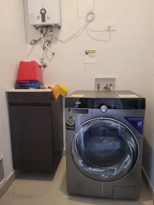 a washing machine in a laundry room with a counter at Aparta Suite Hotel Rioverde Aeropuerto JMC in Rionegro