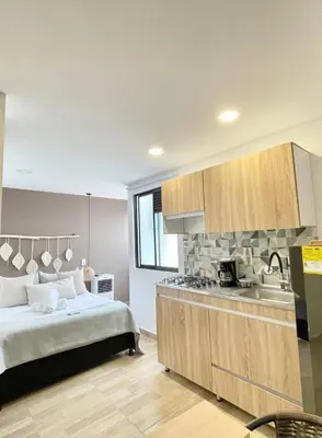 a kitchen with a bed and a sink in a room at Casa palmera cozy loft 301 near everything in Envigado