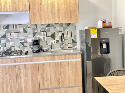 a kitchen with a sink and a refrigerator at Casa palmera cozy loft 301 near everything in Envigado