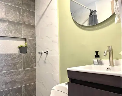 a bathroom with a sink and a toilet and a mirror at Casa palmera cozy loft 301 near everything in Envigado