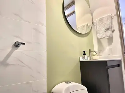 a bathroom with a toilet and a mirror at Casa palmera cozy loft 301 near everything in Envigado