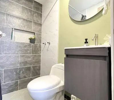 a bathroom with a toilet and a sink and a mirror at Casa palmera cozy loft 301 near everything in Envigado
