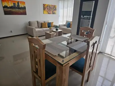 a living room with a table and a couch at departamento amoblado in Sabaneta