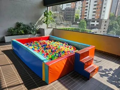 a colorful sandbox with balls in it on a balcony at departamento amoblado in Sabaneta