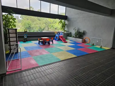 a room with a playground with a colorful carpet at departamento amoblado in Sabaneta
