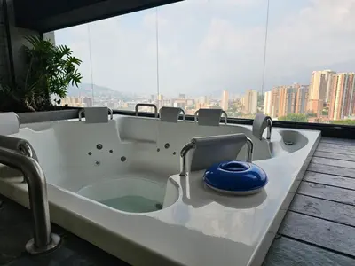 a bath tub in a room with a large window at departamento amoblado in Sabaneta