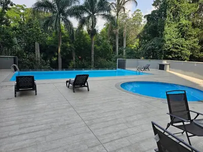 a patio with chairs and a swimming pool at departamento amoblado in Sabaneta