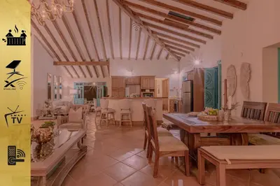 a kitchen and dining room with a table and chairs at Vista Bonita - Hacienda Guatape in Guatapé