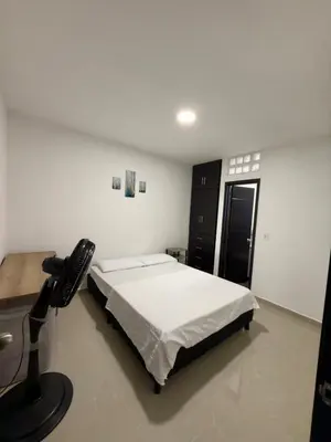 a bedroom with a bed and a desk and a microphone at Estrena confortable casa in Mariquita